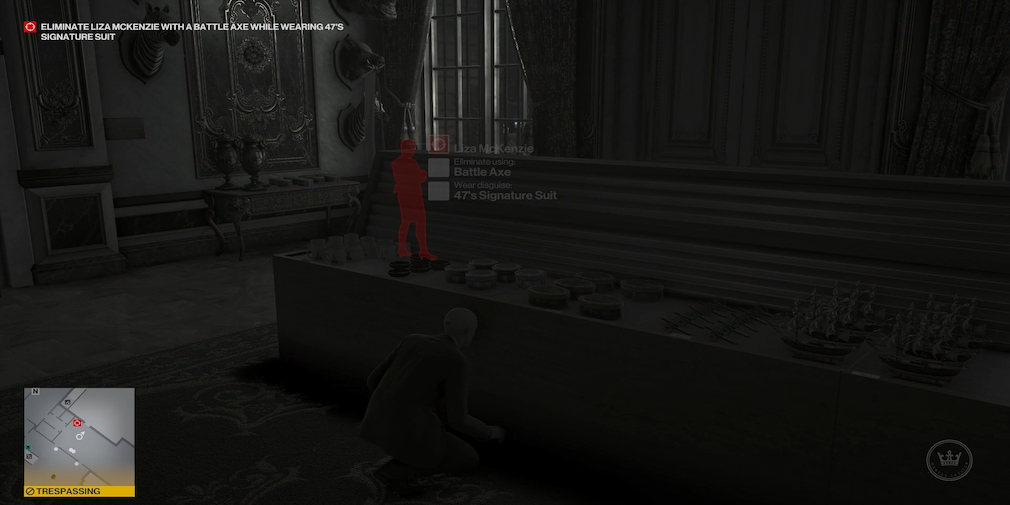 A man is crouched behind a table, as another is indicated in red on the other side