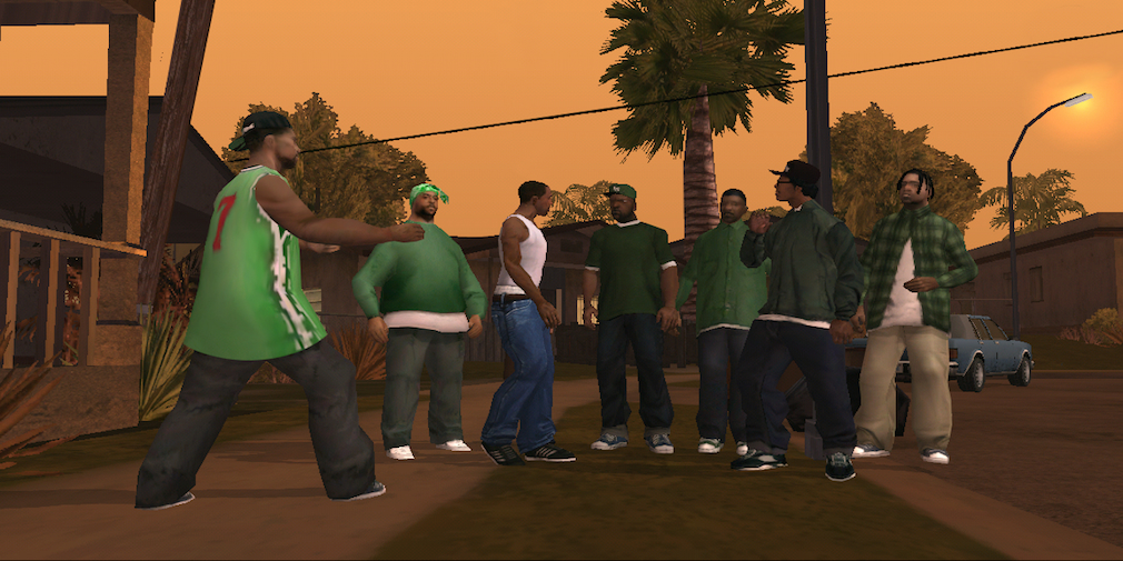 A group of 7 gang members are standing around talking